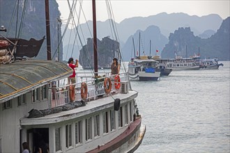 Tourist boats and limestone monolithic islands in Ha Long Bay