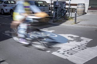 A cyclist rides over markings on a bicycle road in Berlin