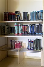 Rubber boots standing on a shelf in a kindergarten