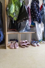 Jackets and shoes at a cloakroom in a kindergarten