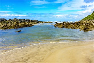 Image of Prainha beach located in Serra Grande in Bahia with blue and transparent water and surrounded by rocks and vegetation
