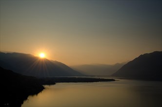 Sunrise over the mountain and alpine lake Lago Maggiore