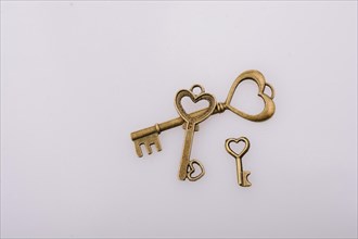 Heart shaped retro metal keys on white background