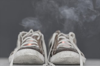 Pair of shoes with smoke and fire