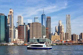 New York City Manhattan skyline with World Trade Center skyscraper and ferry in New York