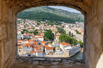 View of the old town through an opening in the wall of the fortress in Dubrovnik
