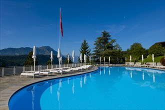 Swimming Pool with Mountain View in a Sunny Summer Day in Burgenstock