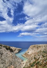 Vertical view of z-shaped cove or bay in typical summer Greek or Cretan landscape on sunny day. Great blue sky and beautiful clouds. Seitan Limania
