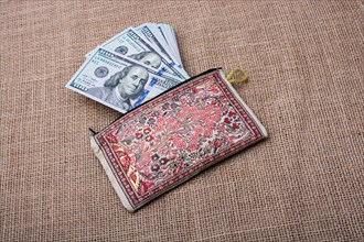 Banknote of US dollar in a purse on a linen canvas