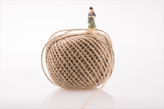 Woman figure at the top a linen spool of thread on a white background