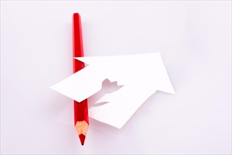 Color pencil near a paper house on a white background