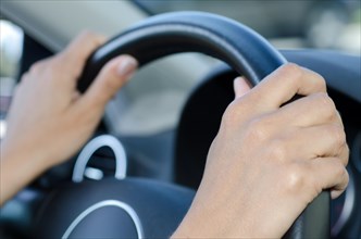 Woman Holding a Steering Wheel