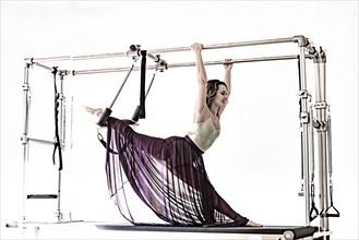 Woman Exercising on Pilates Machine with Transparent Skirt