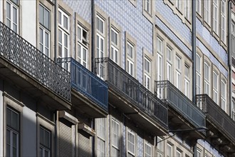 Row of houses with azulejo facades and iron balconies