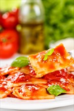 Ravioli Italian pasta in tomato sauce eat with fork lunch dish on plate in Stuttgart