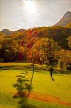 Golfer Putting on Putting Green on Golf Course Menaggio with Mountain View in Autumn in Lombardy