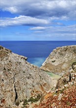 Vertical view of z-shaped lagoon in typical Greek or Cretan landscape on sunny summer day. Great blue sky and beautiful clouds. Secluded swimming