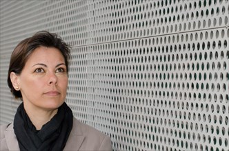 Headshot on a Self Confident Woman on Modern Design Wall