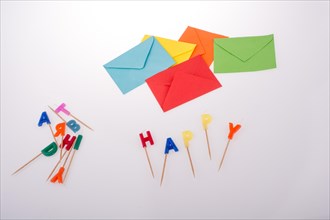 Colored envelopes and Color candles on sticks write happy