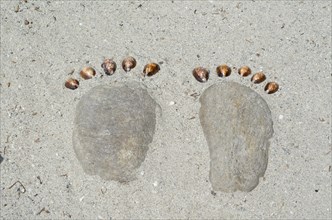Footprints Made of Stones in the Sand