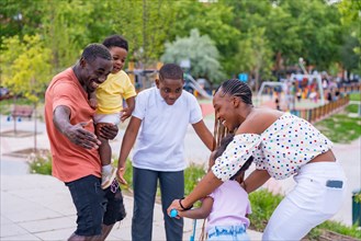 African black ethnic family with children in playground