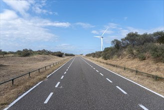 Access road to Banjaard beach with wind turbines of the Oosterschelde Barrage
