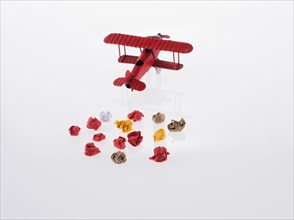 Red airplane and crumpled paper on a white background