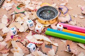 The compass instrument and a few colorful pencils