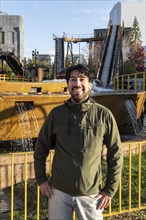 Portrait of latino man posing happy in an amusement park