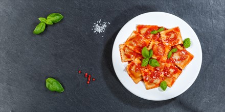 Ravioli Italian pasta eat lunch dish with tomato sauce from above on slate panorama text free space copyspace in Stuttgart
