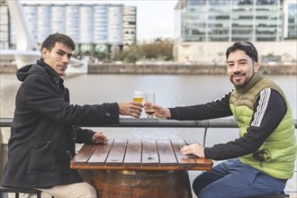 Latin tourists drinking beer at an outdoor bar