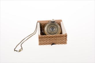 Retro styled pocket watch placed in a straw box