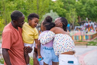 African black ethnic family with children in playground