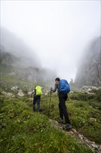 Mountaineers climbing in the fog