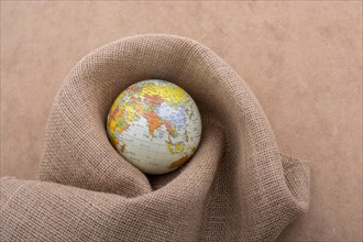 Linen canvas is wrapped around a model globe