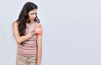 Sore young woman with arm pain isolated. Woman suffering with arm pain