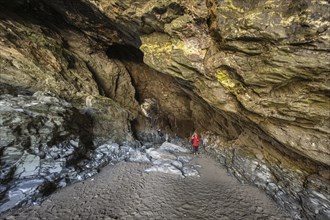 Tourists walk the fabled Merlins Cave