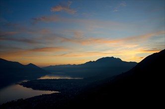 Dusk over an Alpine Lake Maggiore with Orange Clouds in Ticino