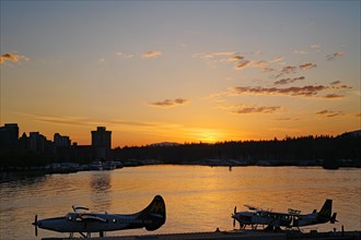 Seaplanes and skyscrapers in the sunset