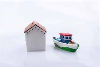 Boat beside a little model house in view