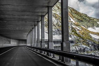 Mountain Road with Open Tunnel with Snow in Switzerland