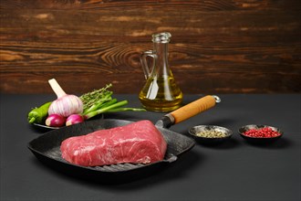 Uncooked beef steak boneless on cast iron skillet