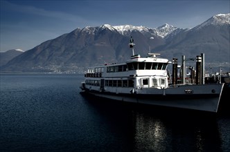 Passenger Ship on Alpine Lake Maggiore with Snow-capped mountain in Ticino