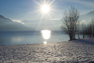 Alpine Lake Maggiore with Snow and Mountain with Sunbeam in Ascona