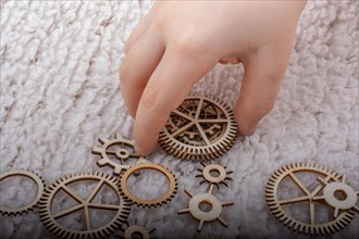 Hand holding gear wheels as the concept of mechanism