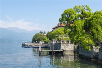 Port and Houe on Waterfront on Lake Orta in a Sunny Day with Mountain in Piedmont