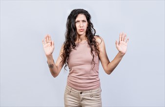 Scared woman with raised hands isolated. Young woman with scared face with raised hands