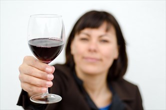 Woman holding up a glass of Red Wine
