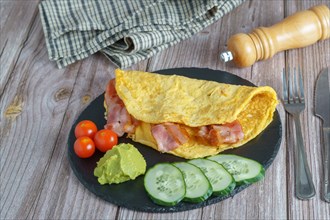 Bacon stuffed omelette with cucumber