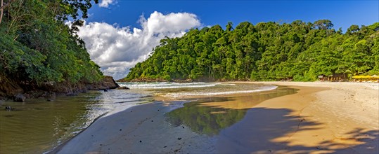 Panoramic image of Ribeira beach surrounded by rainforest and with the river flowing into the sea in Itacare on the south coast of Bahia